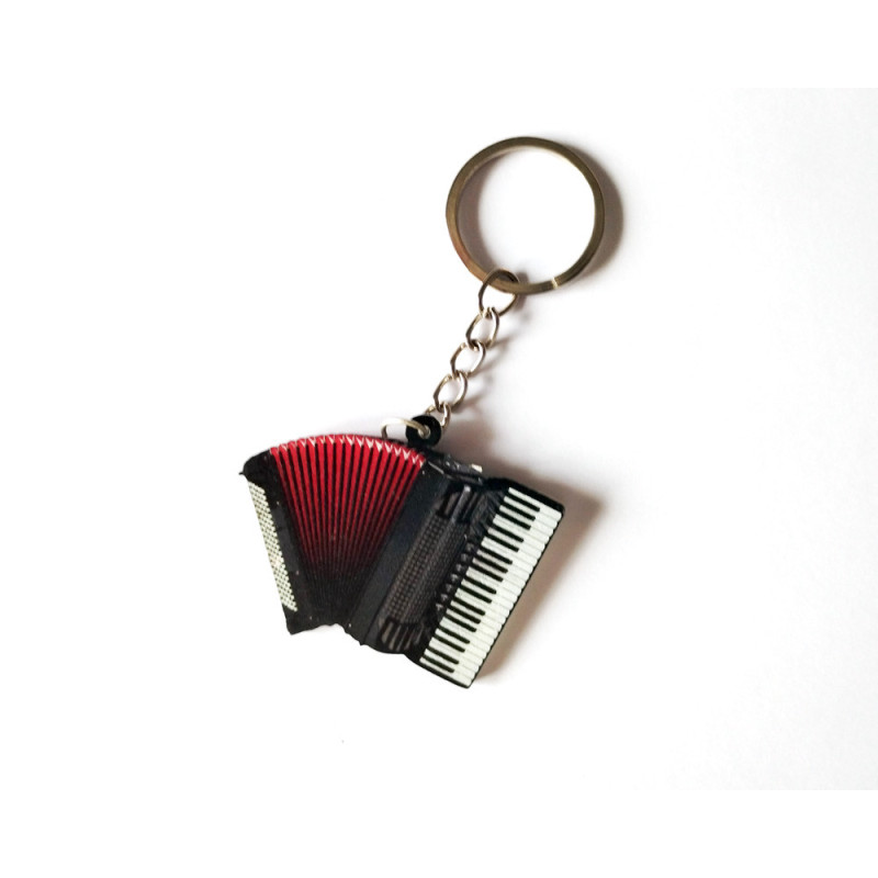 Porte-clés en forme d'accordéon noir avec soufflet rouge et touches de piano