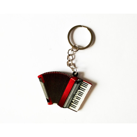 Porte-clés en forme d'accordéon rouge avec soufflet noir et touches de piano