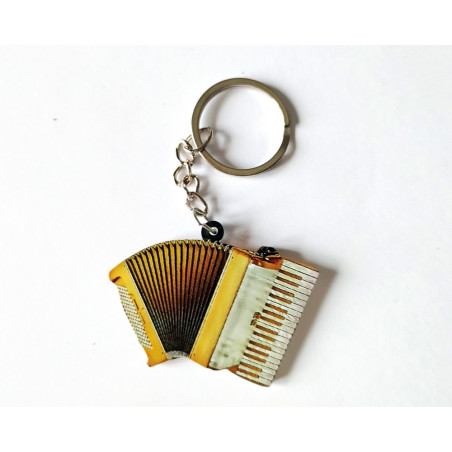 Porte-clés en forme d'accordéon doré avec touches de piano