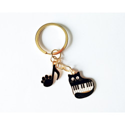 Porte-clés représentant un chat sur un clavier de piano