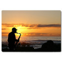 Planche à découper en verre : Saxophoniste sur une plage